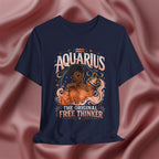 Navy blue t-shirt with Aquarius design featuring a black woman and text 'The original free thinker' on a pink fabric background