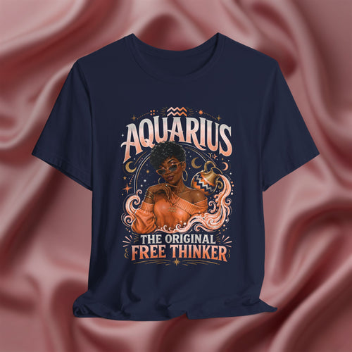 Navy blue t-shirt with Aquarius design featuring a black woman and text 'The original free thinker' on a pink fabric background