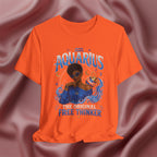 Orange t-shirt with Aquarius design featuring a black woman and text 'The original free thinker' on a pink fabric background