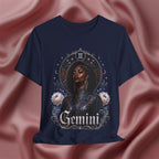 Navy blue t-shirt with a graphic design of a woman, flowers, and the word 'Gemini' on a pink fabric background.