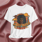 White t-shirt with a graphic design featuring a woman with an afro and the text 'Sagittarius Energy' 