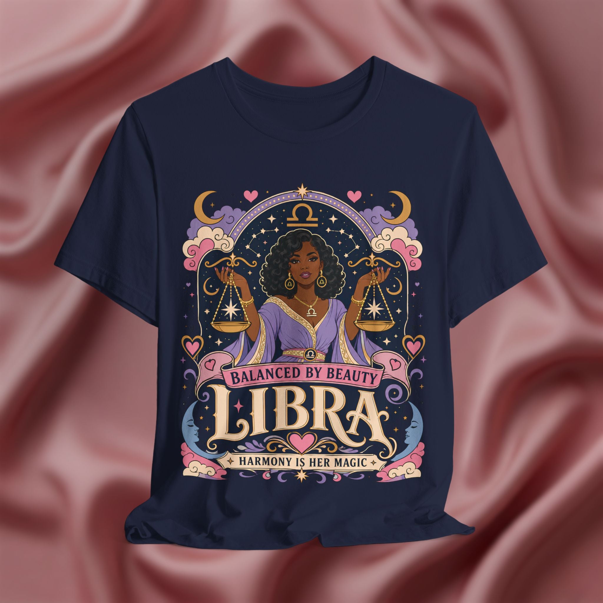 Navy blue t-shirt with Libra zodiac design on a pink fabric background