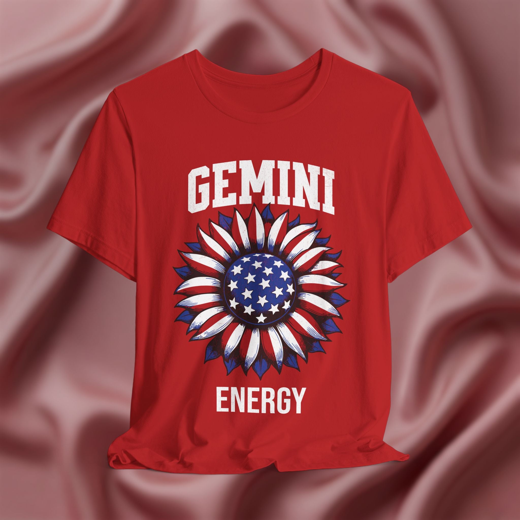 Red t-shirt with with American flag sunflower and 'GEMINI ENERGY' text on a textured pink background