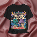 Black t-shirt with colorful Pisces zodiac design on a pink fabric background