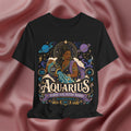 Black t-shirt with Aquarius zodiac design on a pink fabric background