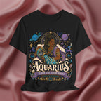 Black t-shirt with Aquarius zodiac design on a pink fabric background