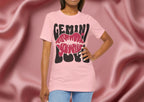 Person wearing a pink t-shirt with 'GEMINI' and lips design on a pink background