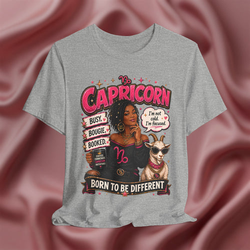 Gray t-shirt with Capricorn zodiac design featuring a woman and goat on a pink fabric background