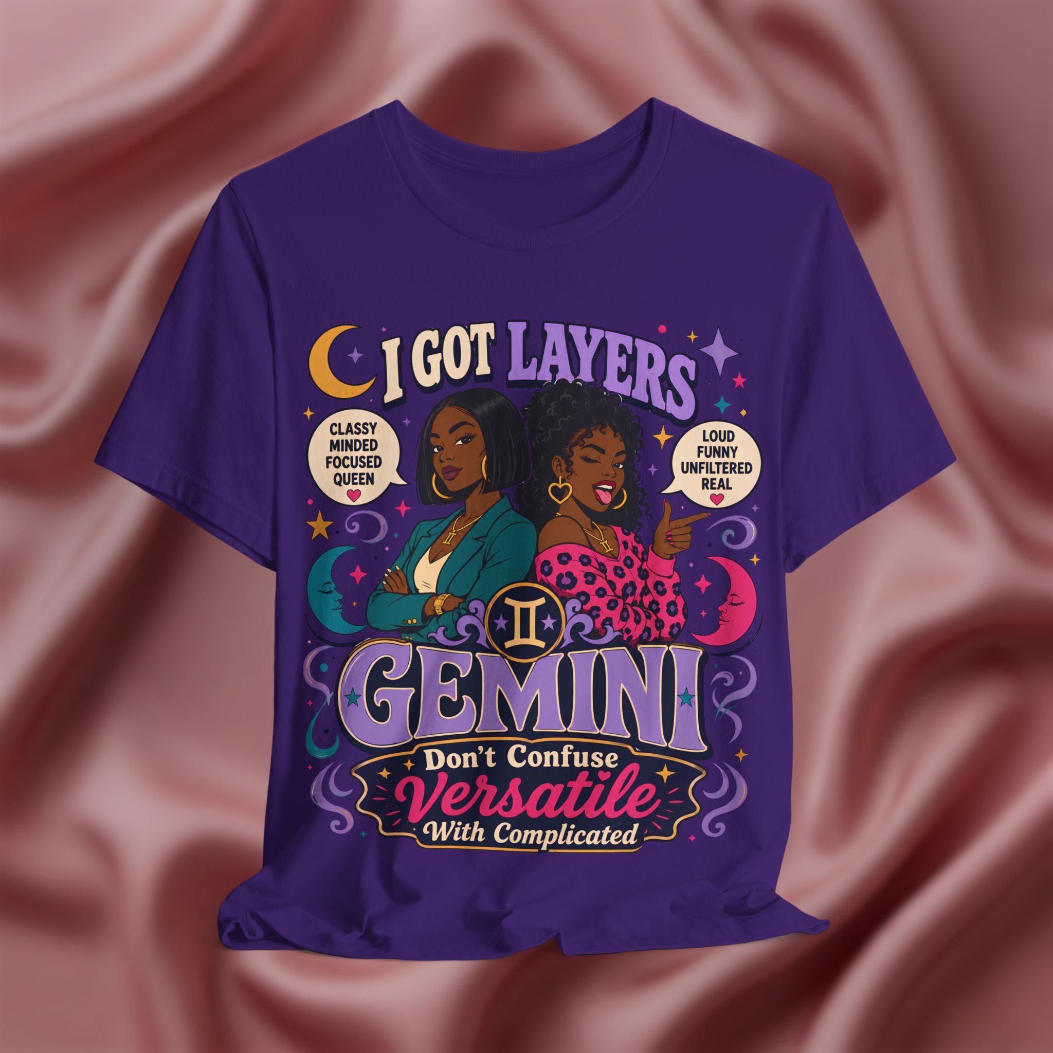 Purple t-shirt with Gemini zodiac design on a pink fabric background