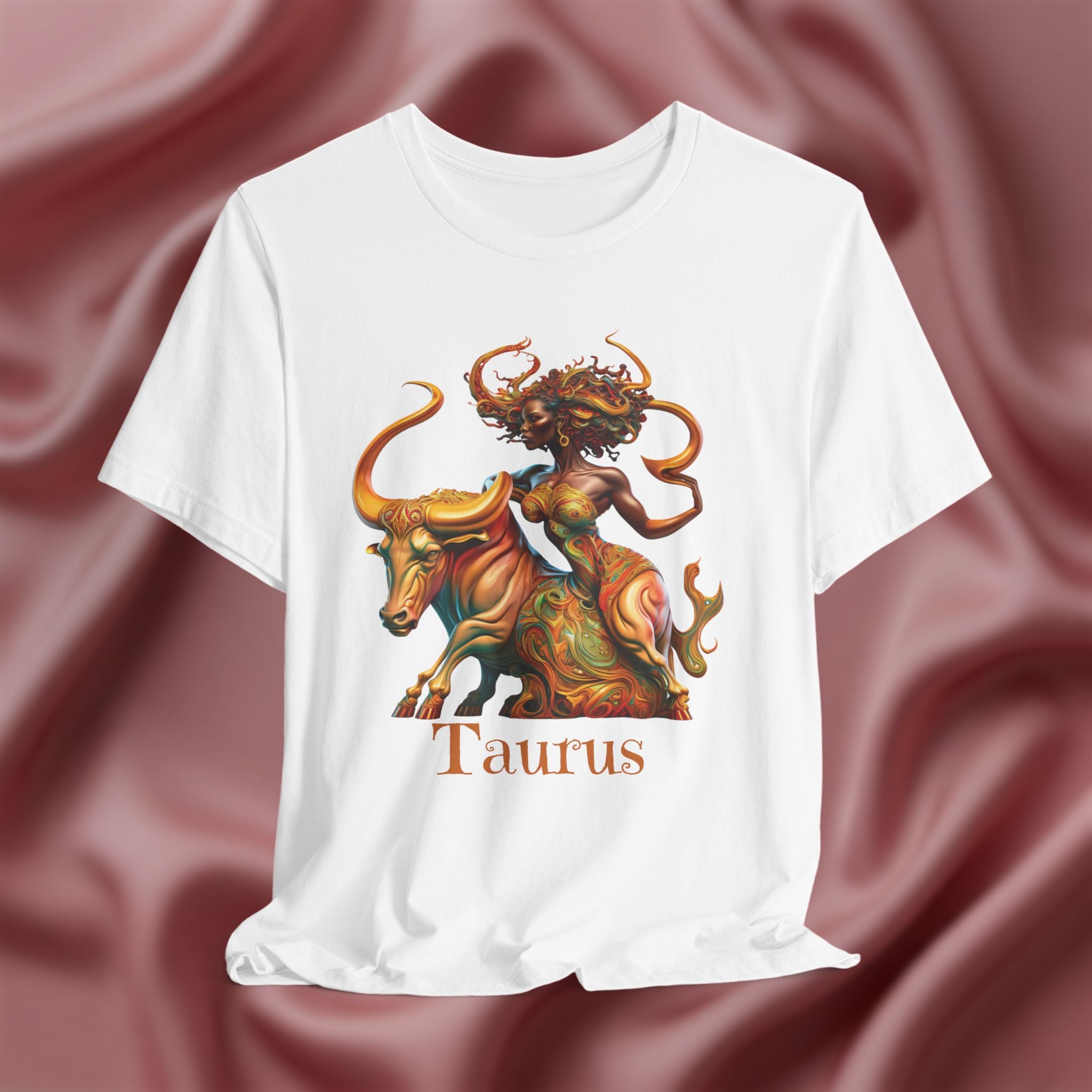 White t-shirt with Taurus zodiac design  featuring a bull and black woman on a pink fabric background