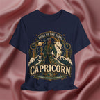 Navy blue t-shirt with Capricorn zodiac design on a pink fabric background