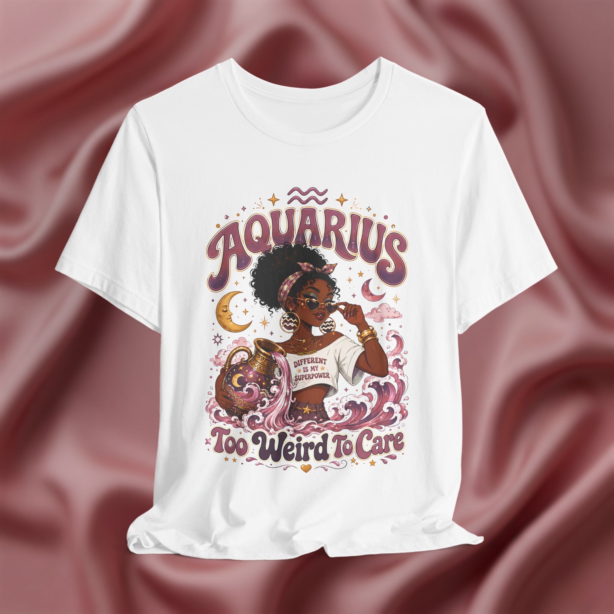 White t-shirt with 'Aquarius Too Weird To Care' design featuring a black woman wearing a t-shirt with the text 'different is my superpower' on a pink fabric background