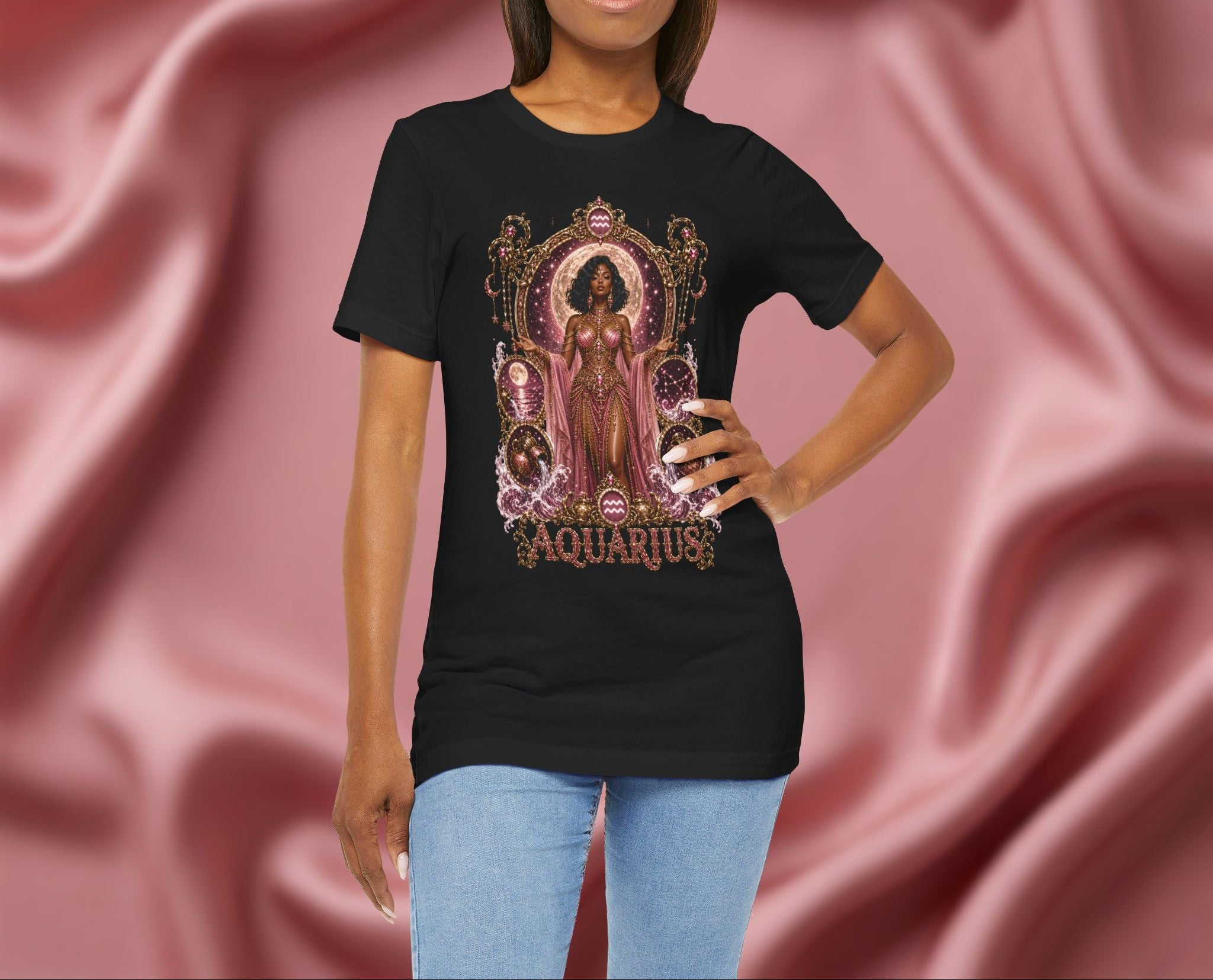 Person wearing a black t-shirt with 'Aquarius' design featuring a woman in a pink dress on a pink fabric background