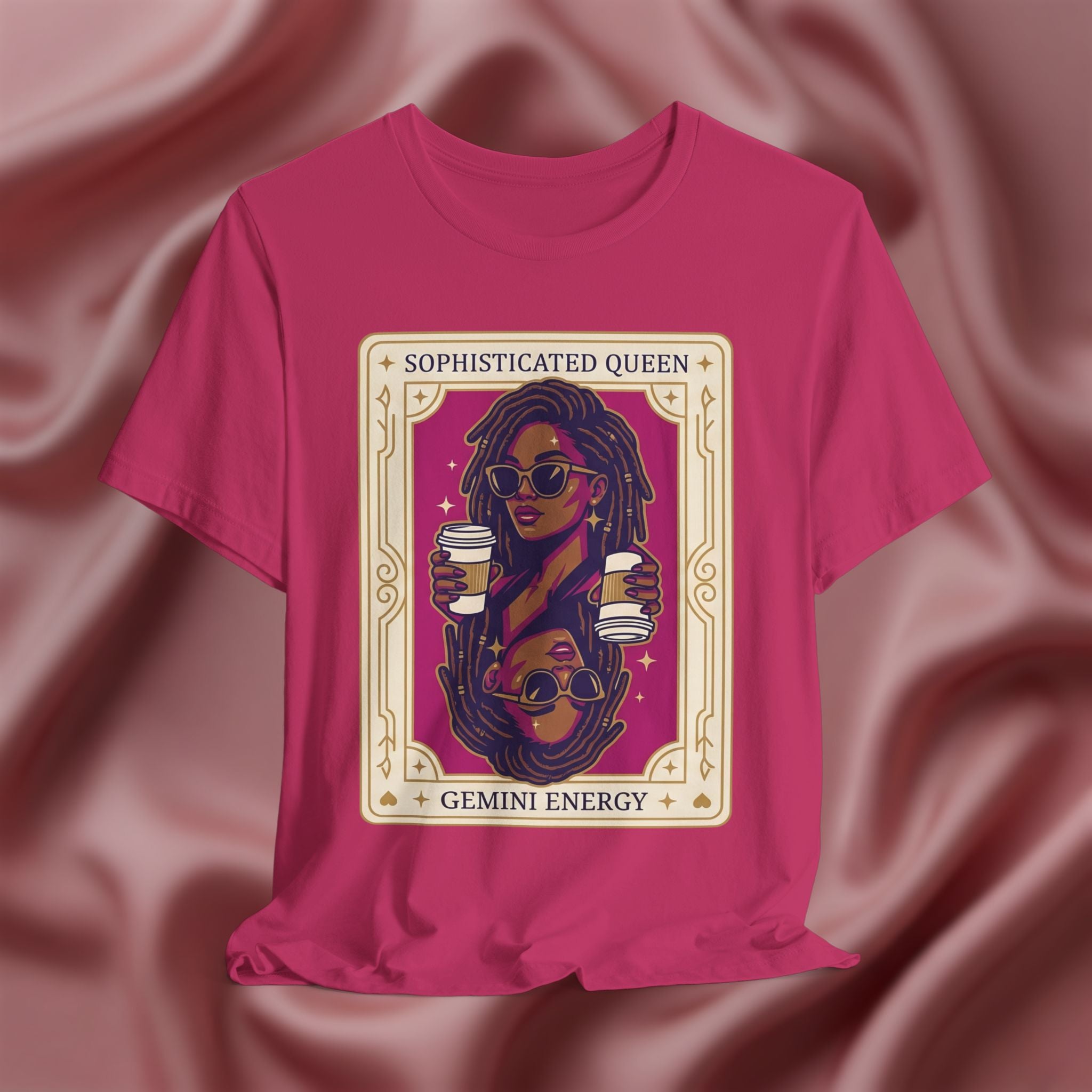 Sophisticated Queen Gemini Energy Pink t-shirt with a graphic design of a woman holding coffee cups on a pink fabric background