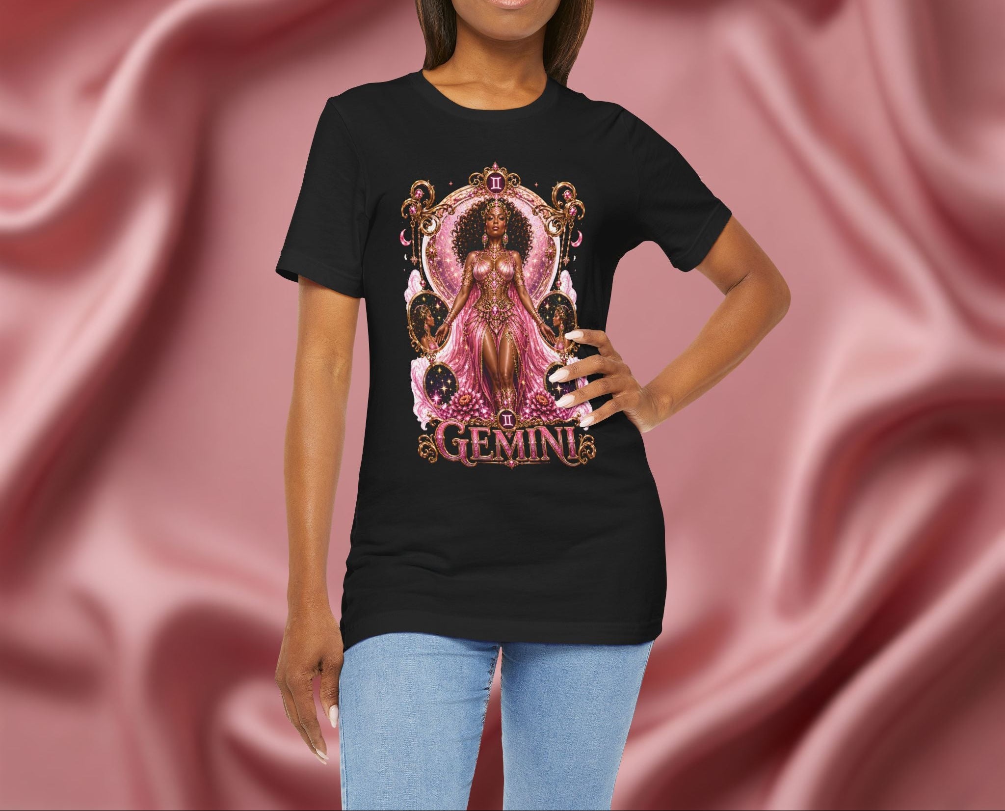 Woman wearing a black t-shirt with 'Gemini' design featuring a woman in a pink dress on a pink fabric background