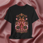 Black t-shirt with Gemini zodiac design on a pink fabric background