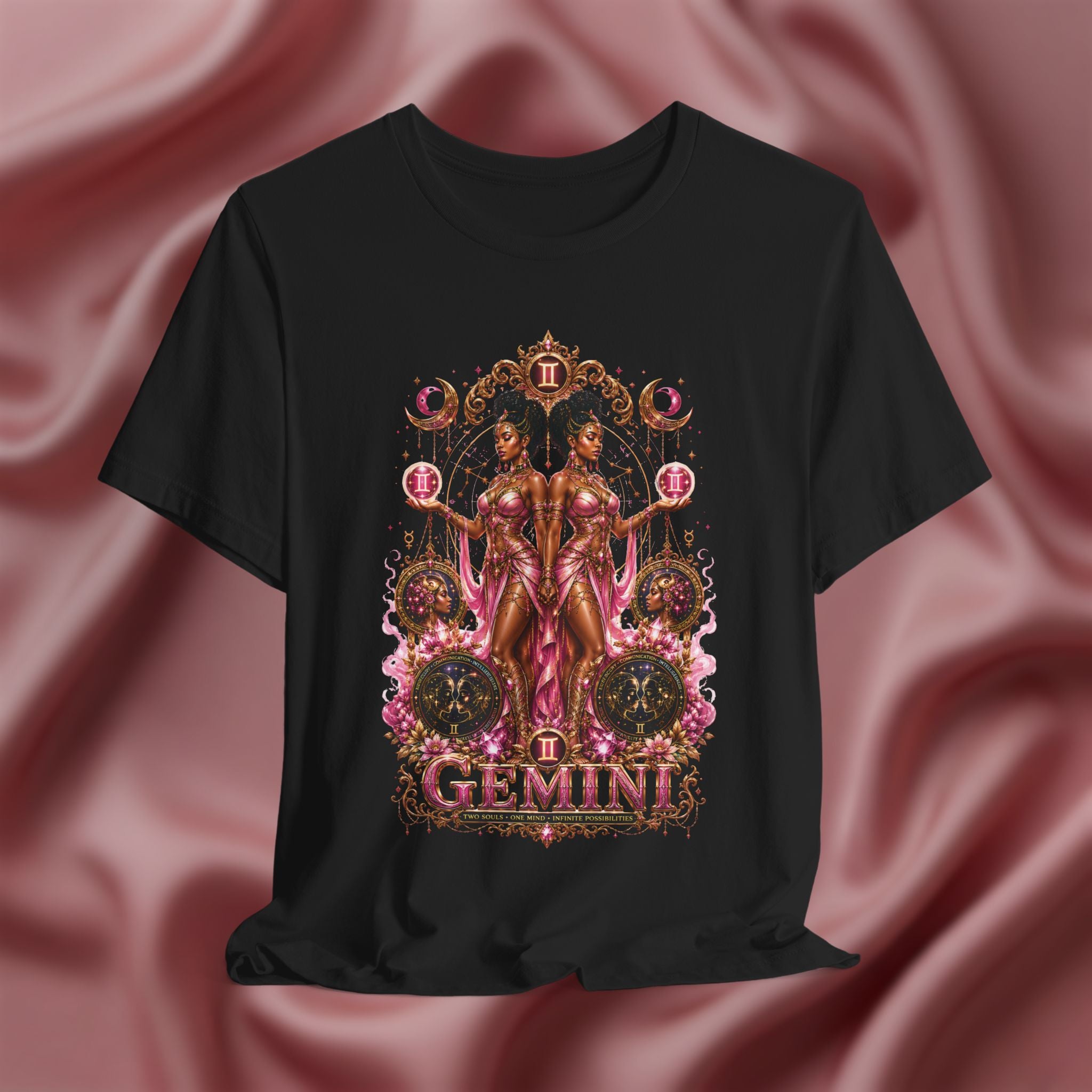 Black t-shirt with Gemini zodiac design on a pink fabric background