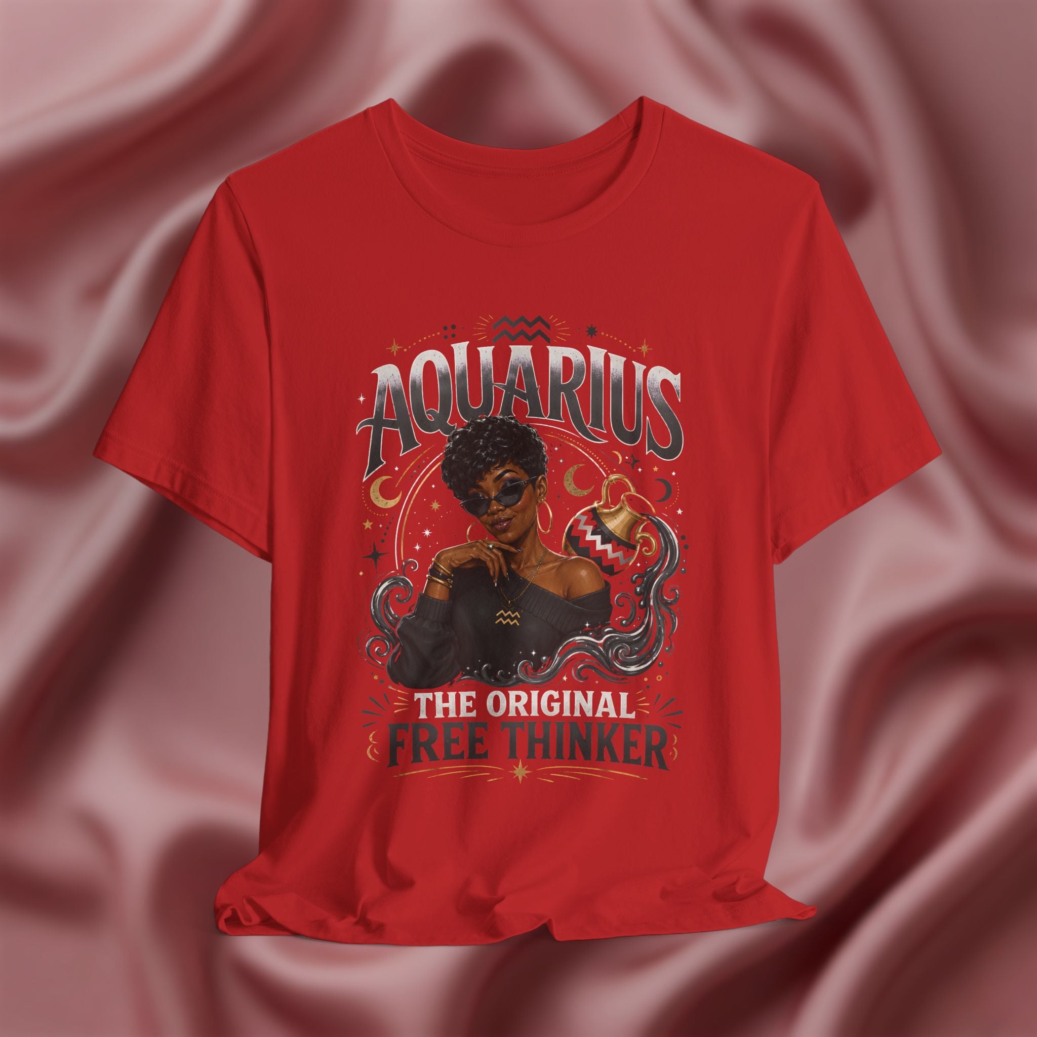 Red t-shirt with Aquarius design featuring a black woman and text 'The original free thinker' on a pink fabric background