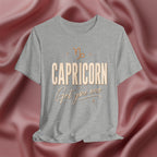 Athletic Heather t-shirt with 'Capricorn Get you one' text on a pink fabric background