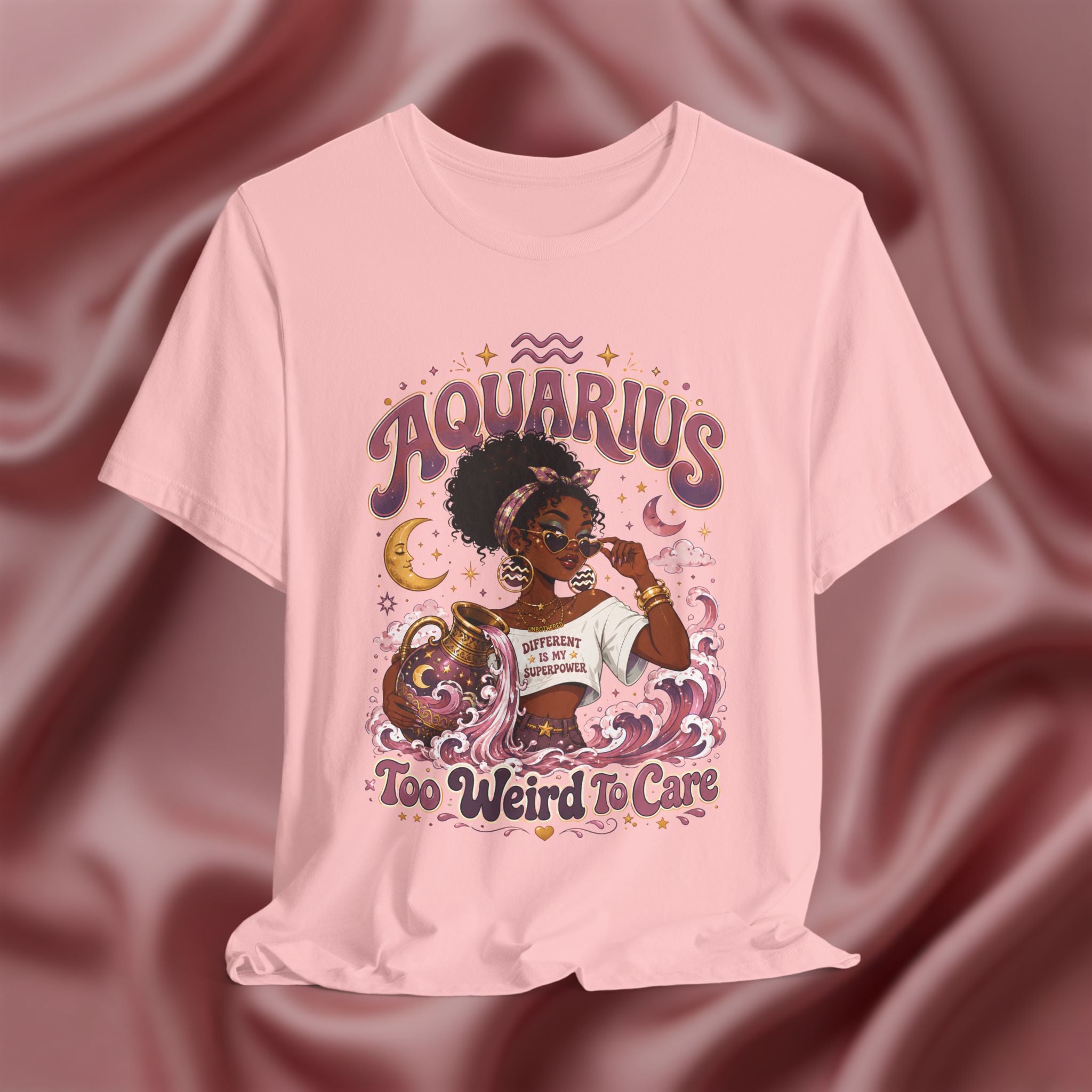 Soft Pink t-shirt with 'Aquarius Too Weird To Care' design featuring a black woman wearing a t-shirt with the text 'different is my superpower' on a pink fabric background