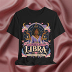 Black t-shirt with Libra zodiac design on a pink fabric background