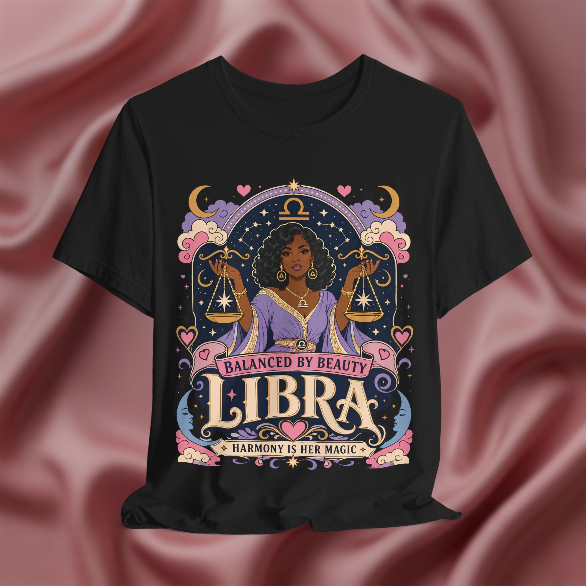 Black t-shirt with Libra zodiac design on a pink fabric background