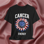 Black t-shirt with American flag sunflower and 'CANCER ENERGY' text on a textured pink background