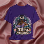 Purple t-shirt with Pisces zodiac design on a pink fabric background
