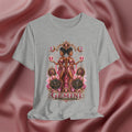 Gray t-shirt with Gemini zodiac design on a pink fabric background