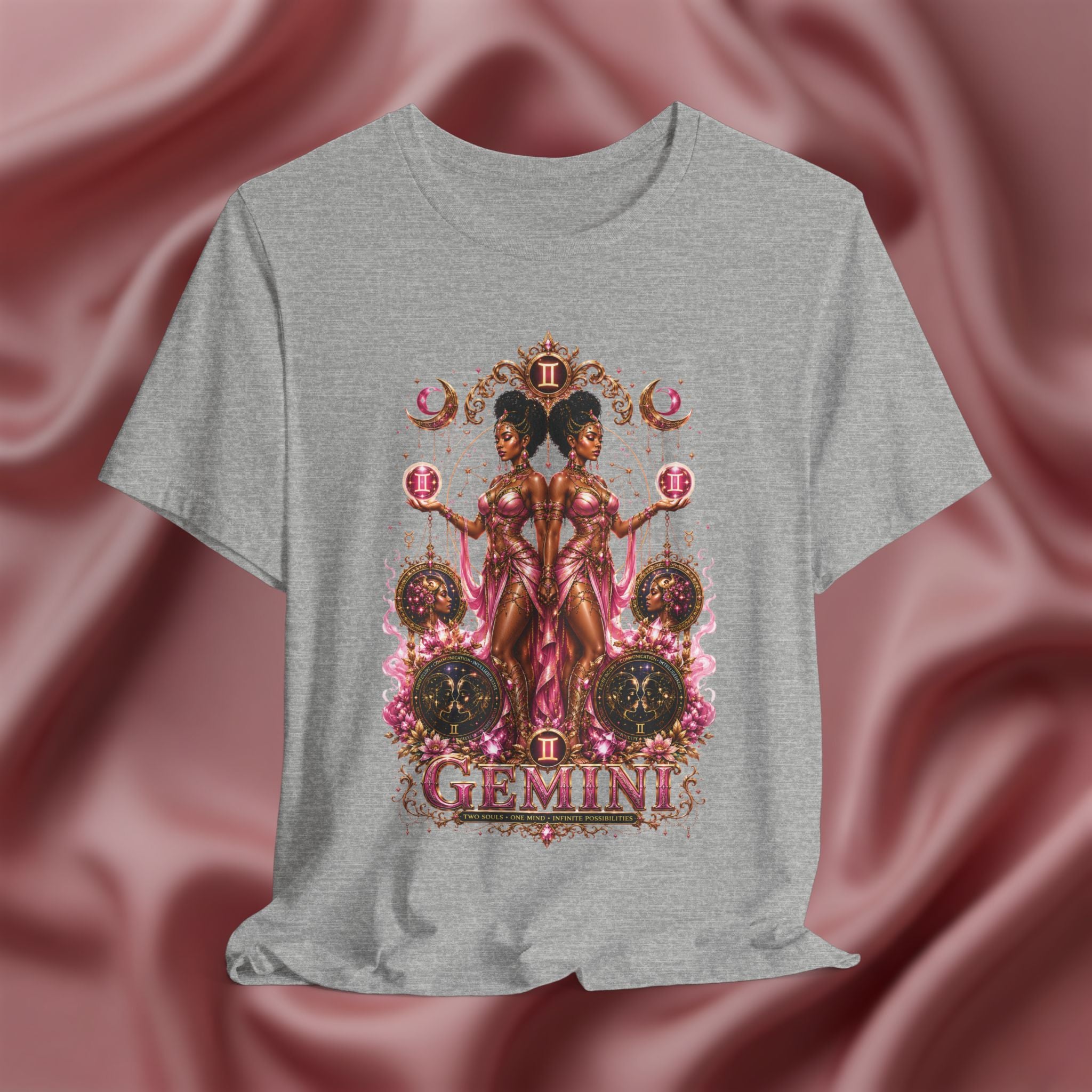Gray t-shirt with Gemini zodiac design on a pink fabric background