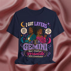 Navy blue t-shirt with Gemini zodiac design on a pink fabric background