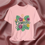 Pink t-shirt with 'Gemini' design featuring flowers and leaves on a maroon fabric background
