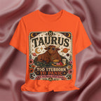 Orange t-shirt with Taurus zodiac design on a textured brown background