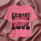 Pink t-shirt with 'GEMINI LOVE' design on a textured brown background