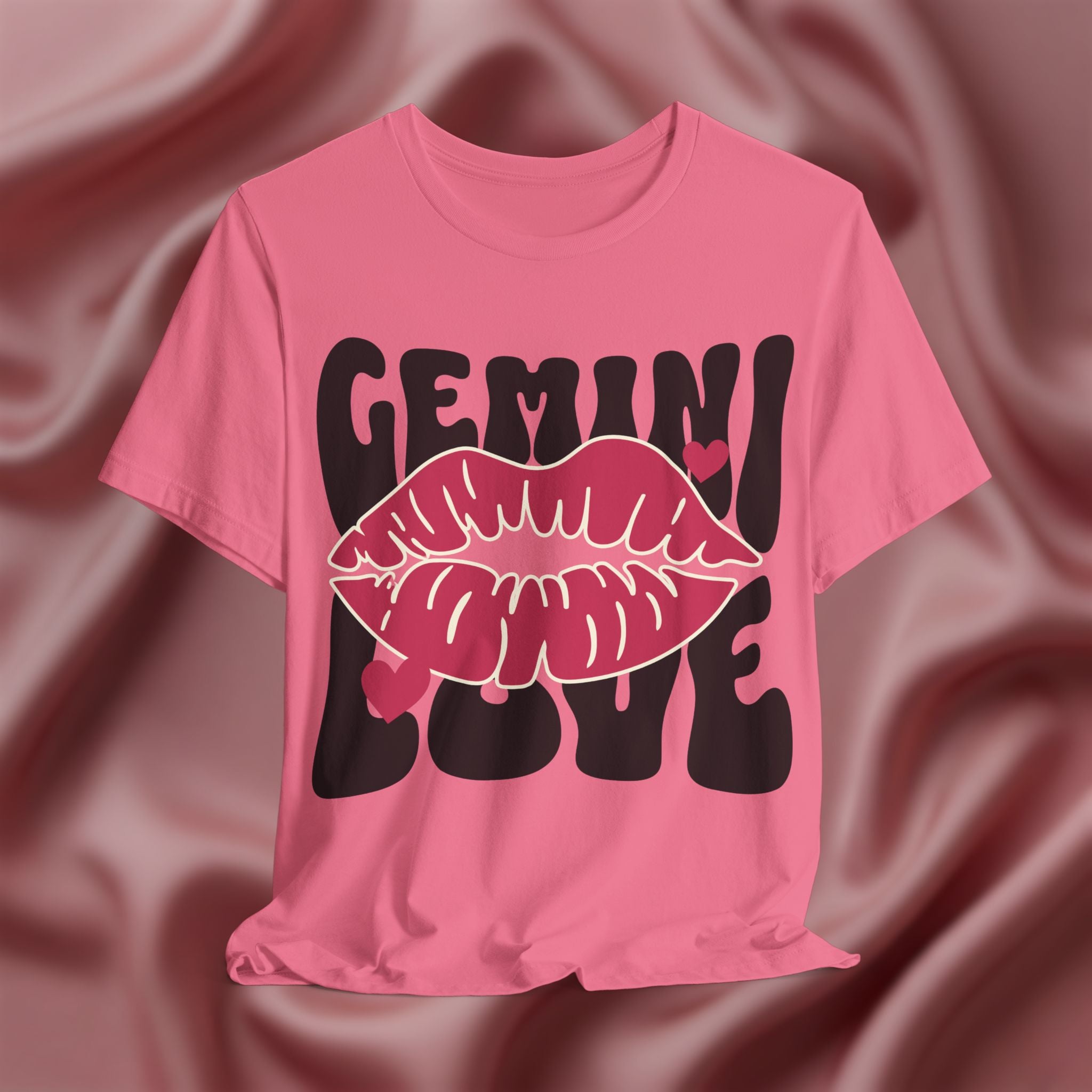 Pink t-shirt with 'GEMINI LOVE' design on a textured brown background