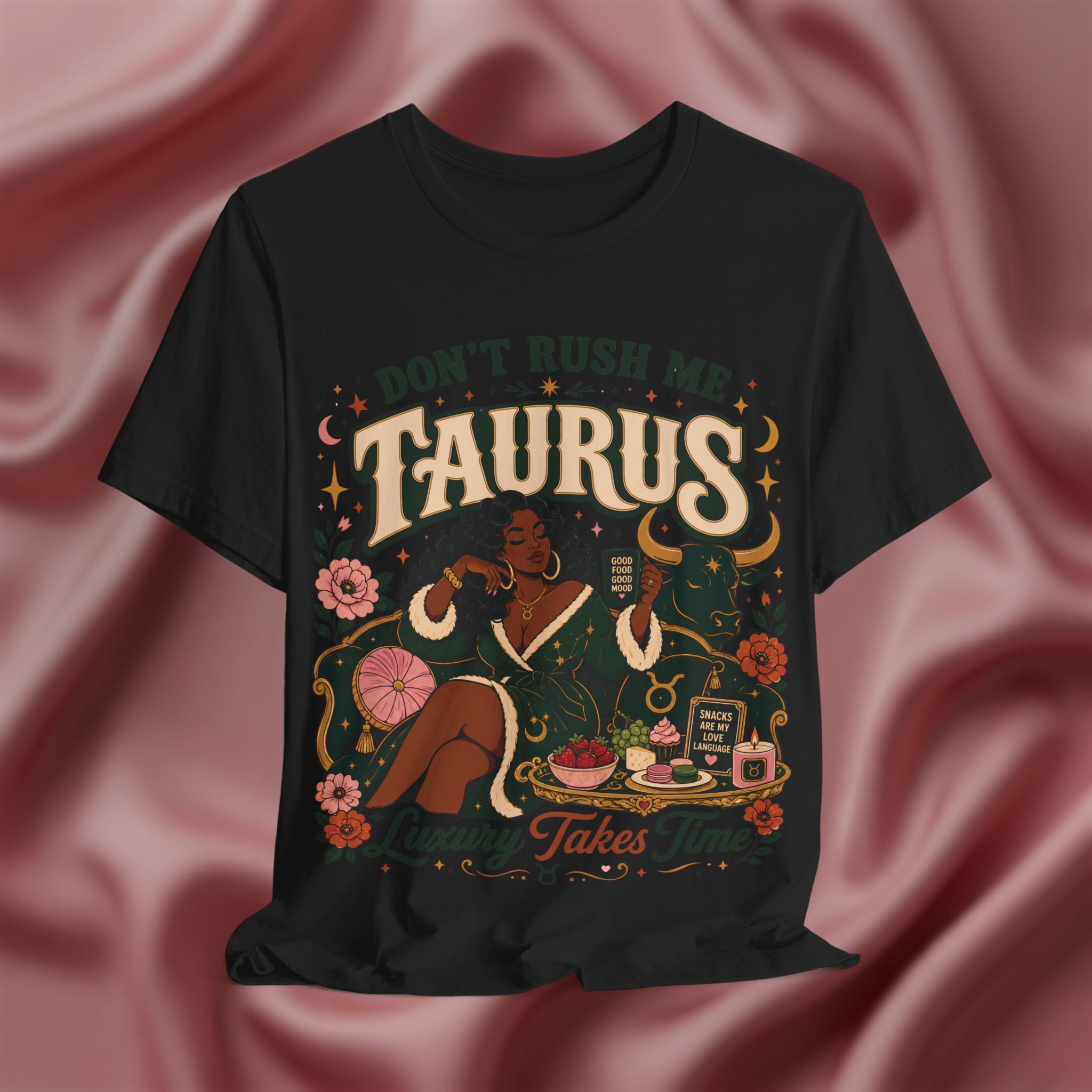 Black t-shirt with 'Don't Rush Me, Taurus, Luxury Takes Time' design against a pink fabric background