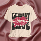 Soft cream t-shirt with 'GEMINI LOVE' design on a maroon fabric background