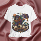 White t-shirt with Sagittarius zodiac design on a maroon fabric background