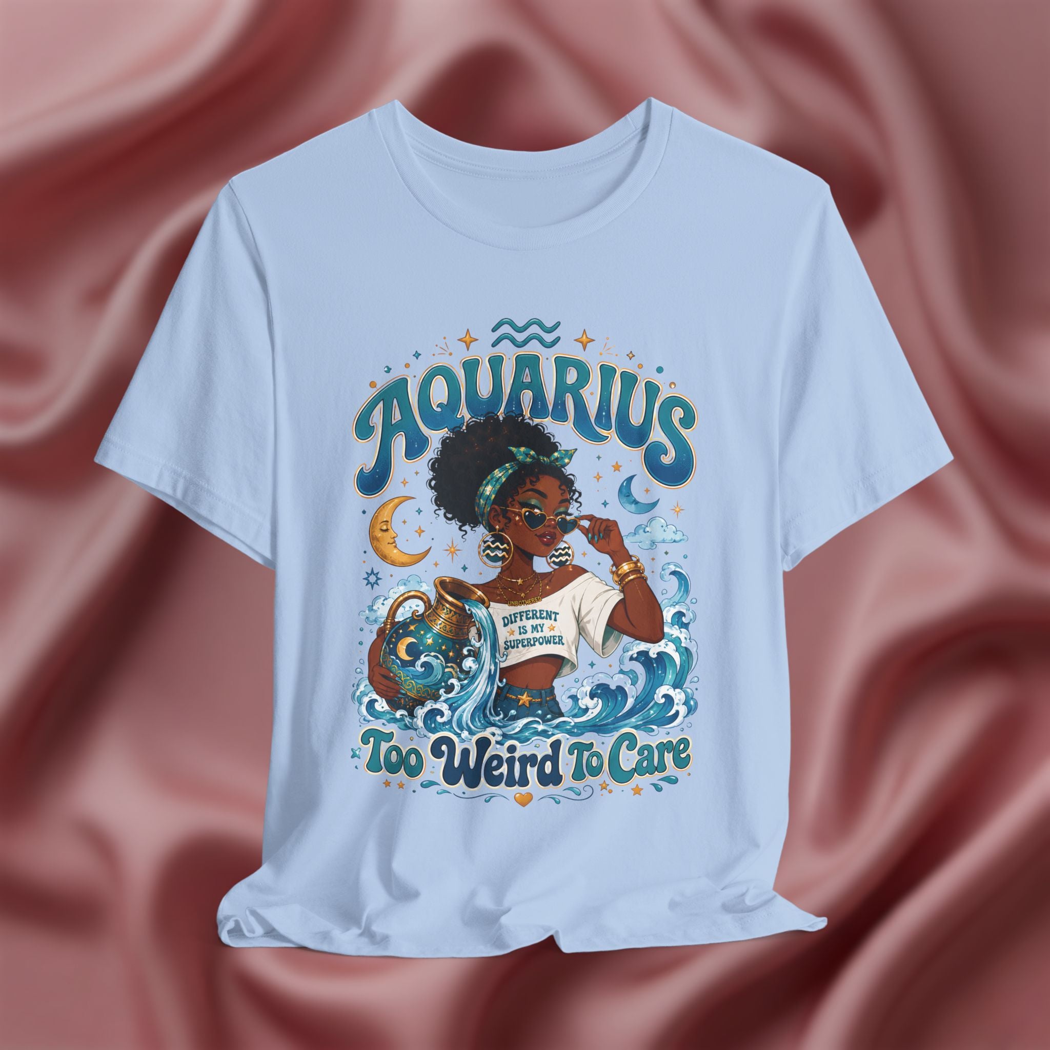 Light blue T-shirt with 'Aquarius Too Weird To Care' design featuring a black woman wearing a t-shirt with the text 'different is my superpower' on a pink fabric background