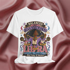 White t-shirt with Libra zodiac design on a maroon fabric background