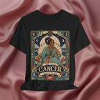 Black t-shirt with Cancer zodiac design on a pink fabric background