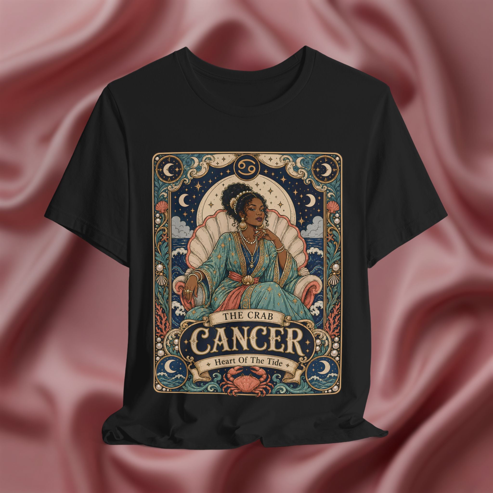 Black t-shirt with Cancer zodiac design on a pink fabric background