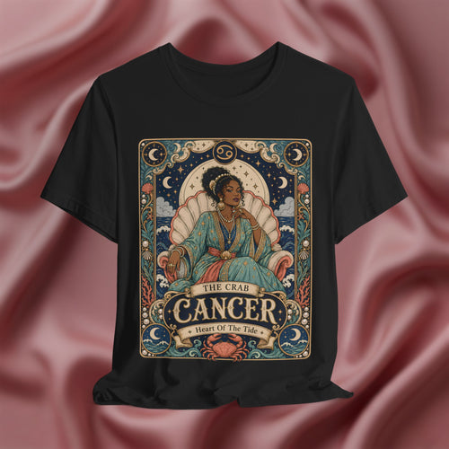 Black t-shirt with Cancer zodiac design on a pink fabric background