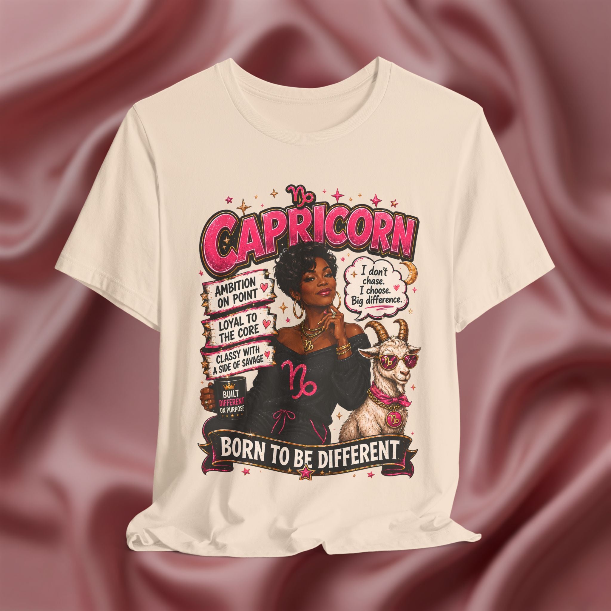 Soft cream t-shirt with Capricorn zodiac design featuring a woman and goat on a maroon fabric background.
