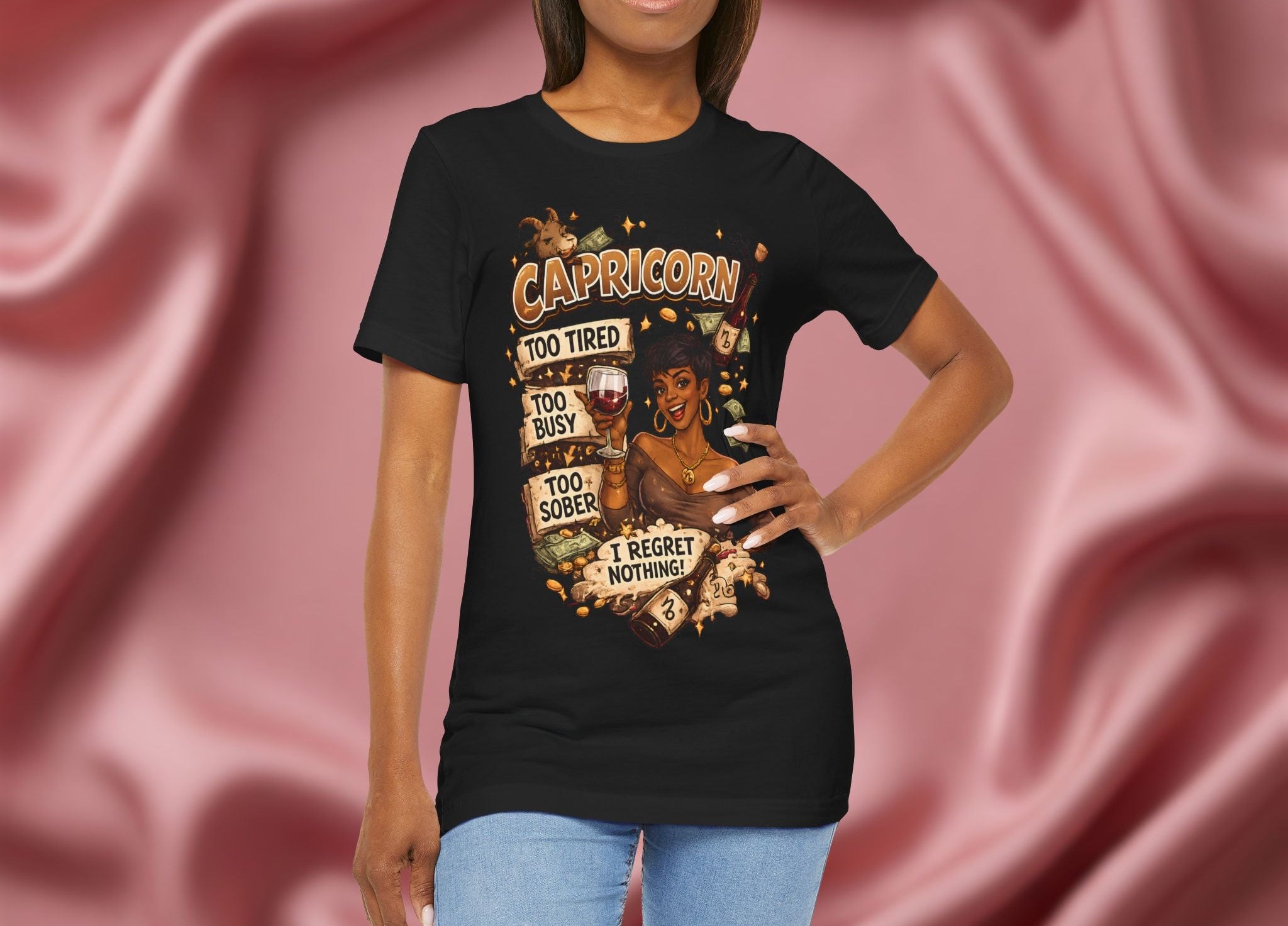 Woman wearing a black t-shirt with Capricorn zodiac design against a pink fabric background